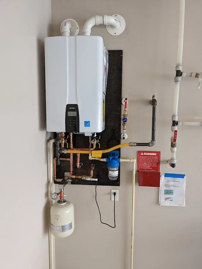 Professional plumber installing copper piping in a Glenpool home